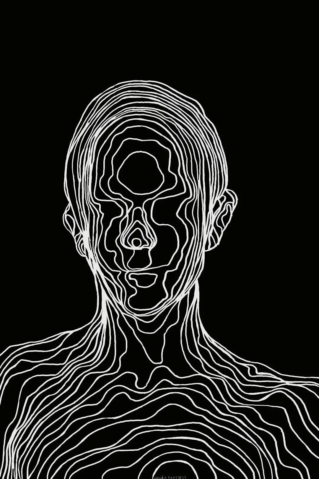 “Man wearing an oversized black t-shirt with a white abstract line-art face graphic printed on the back, paired with black cargo pants against a gray concrete wall background.