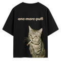 Black AKIDO oversized 100% pure cotton graphic t-shirt featuring a realistic smoking cat illustration and “One More Puff” text print on the back in trendy streetwear style.